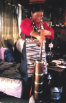 Tibetan woman stirring butter tea using a donmo